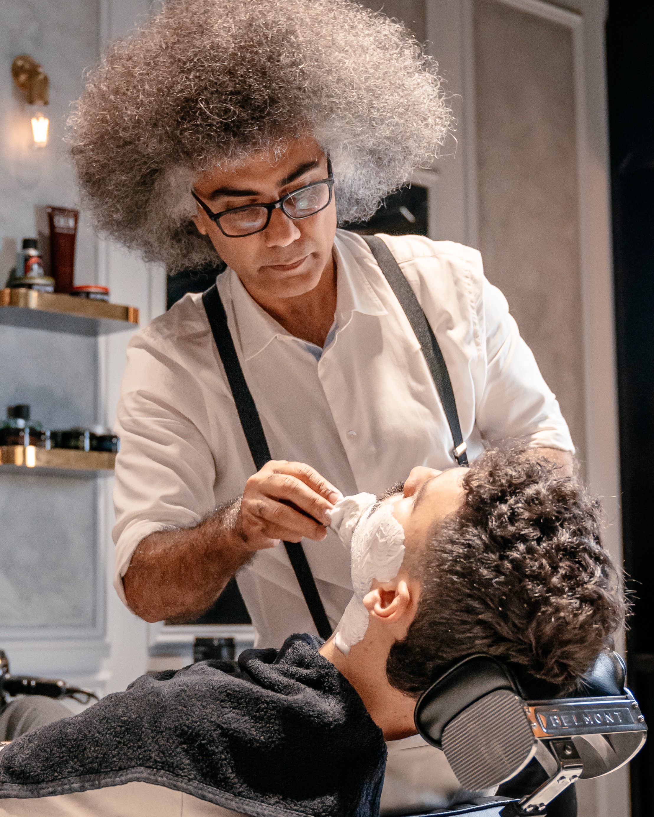 Professional barber providing hot towel treatment