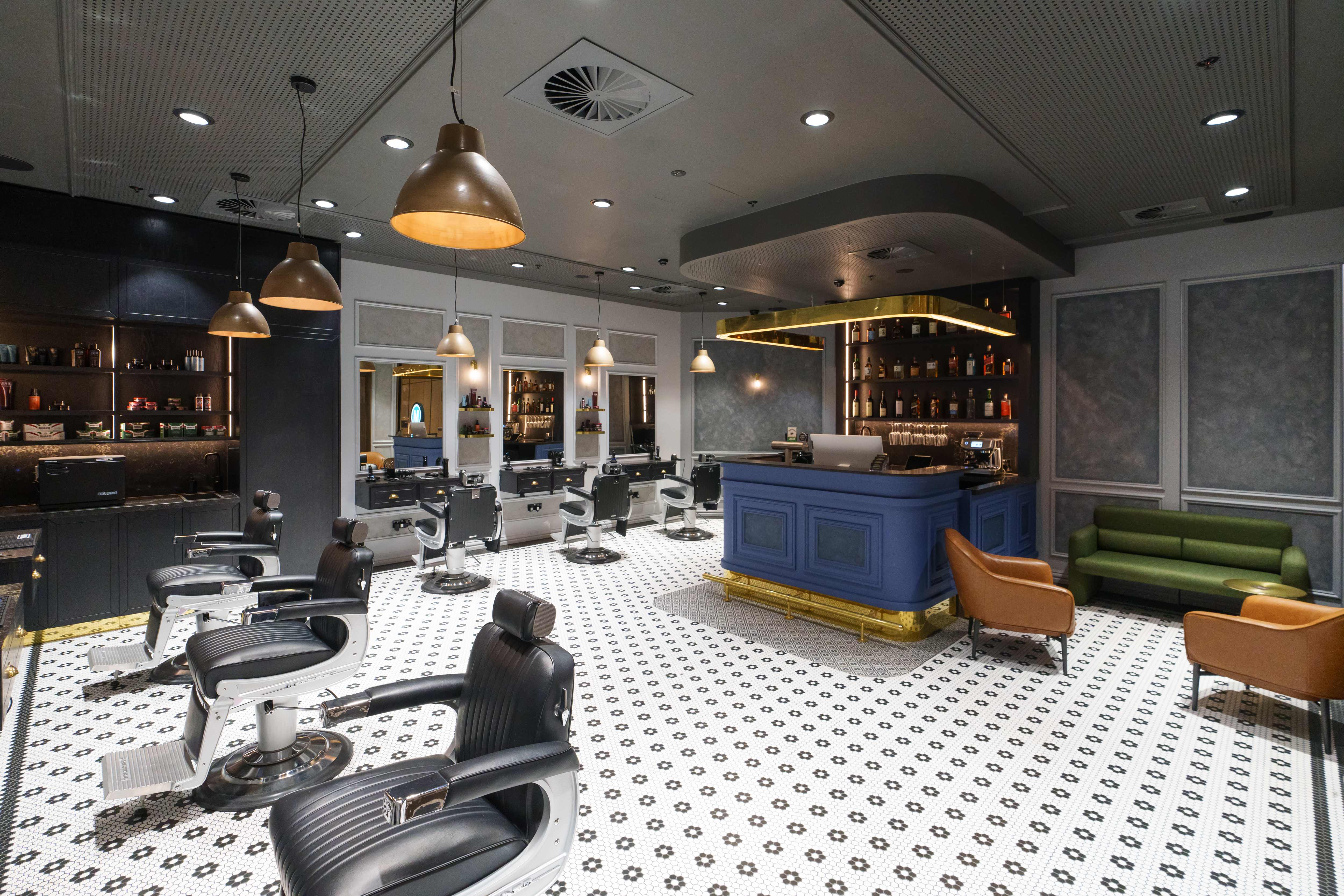 Barber at the Bar luxury interior with barber stations and blue bar