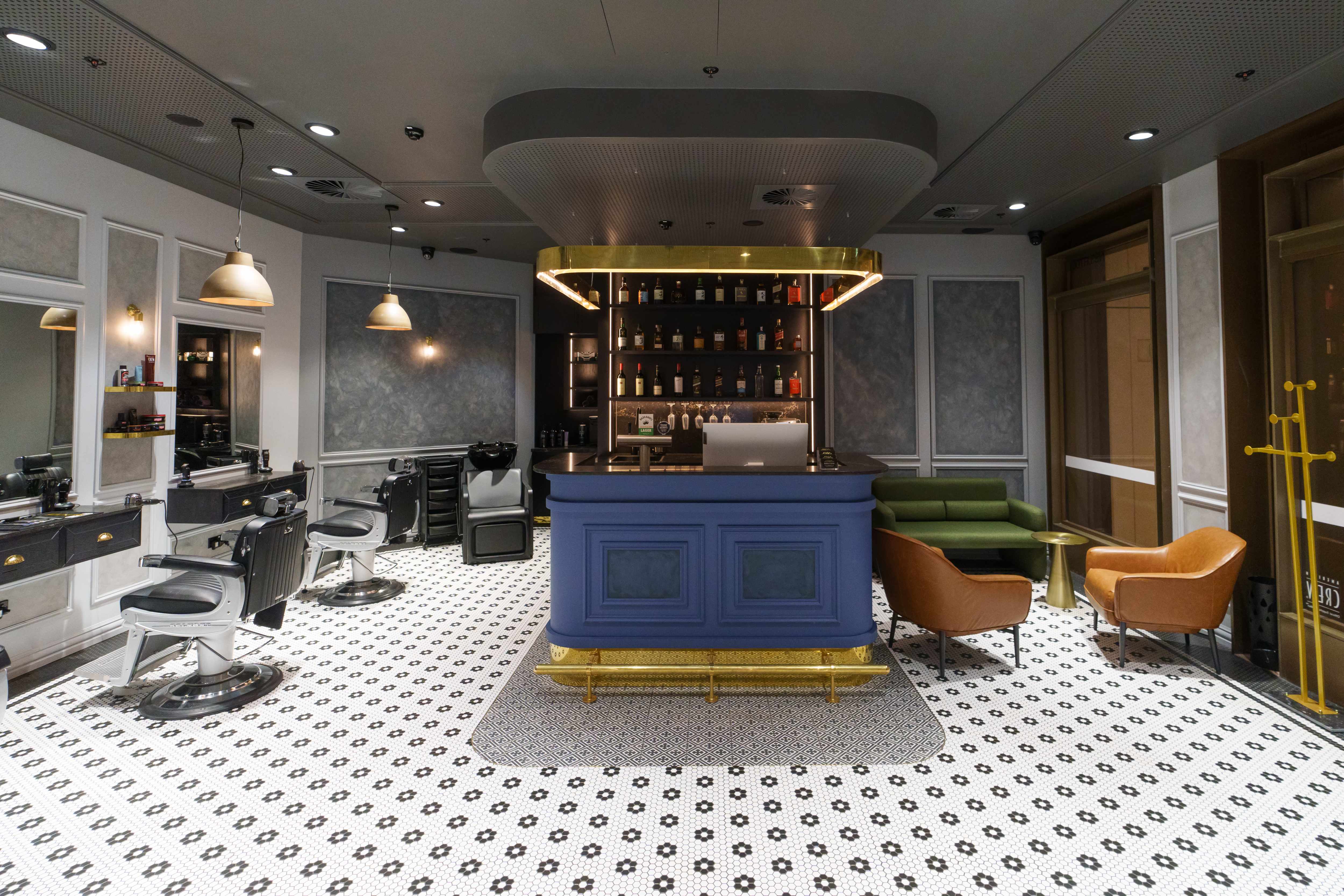 Barber at the Bar interior with blue bar and barber stations